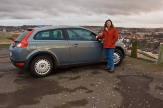 Rhonda in front of her Volvo C30 rental.