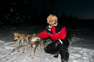 Rhonda petting one of the sled dogs. Yes, it was very cold.
