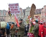 The sign refers to part of Rota ("The Oath") an early 20th-century Polish poem and anthem, once proposed to be the Polish national anthem. It says "We are the Polish nation, the Polish people, From the royal line of Piast."