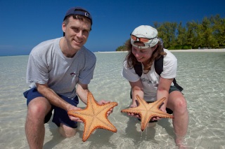 Rhonda and Chad holding some starfish.