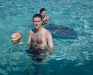 Chad holding a conch shell and Rhonda working on holding a stingray.