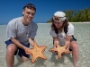 Rhonda and Chad holding some starfish.