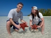 Rhonda and Chad holding some starfish.